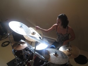 A woman taking drum lessons