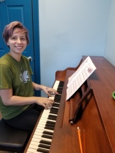 A woman taking piano lessons