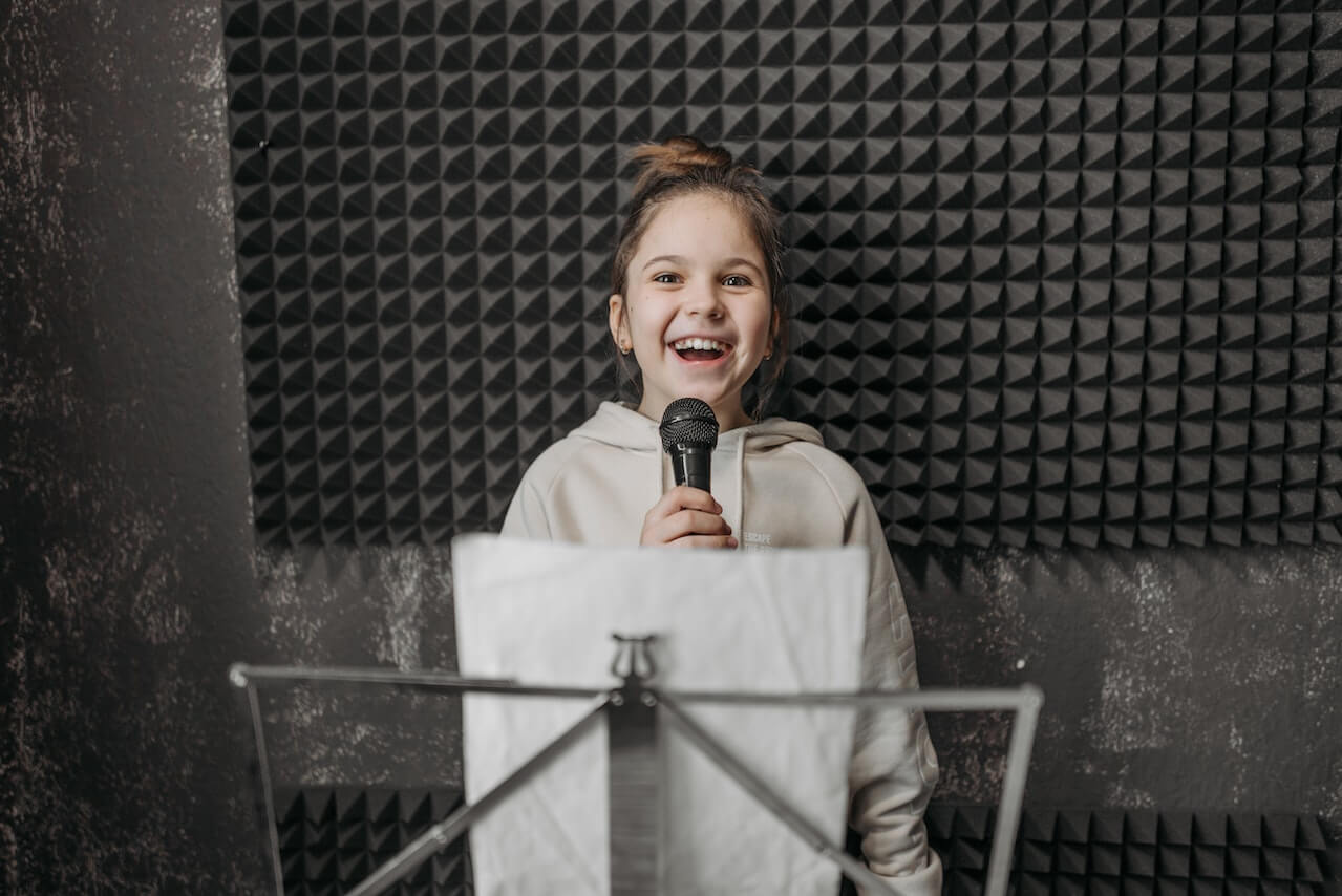 young girl singing during a singing lesson