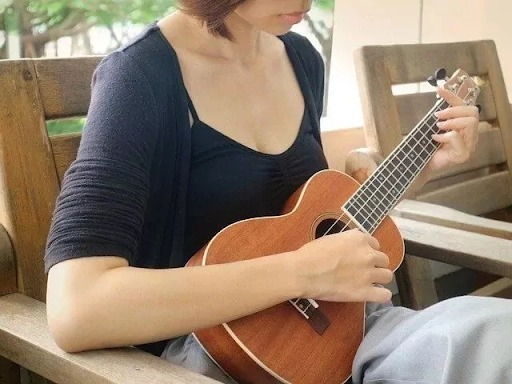 Student playing a soprano ukulele during a private music lesson at a Montreal music school