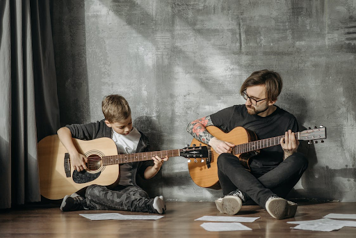 cours de guitare montreal Professeur de guitare enseignant à un enfant pendant un cours de guitare acoustique à Montréal