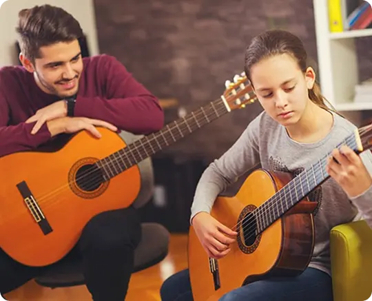 Student taking a guitar lesson at WIMA Pointe-Claire studio